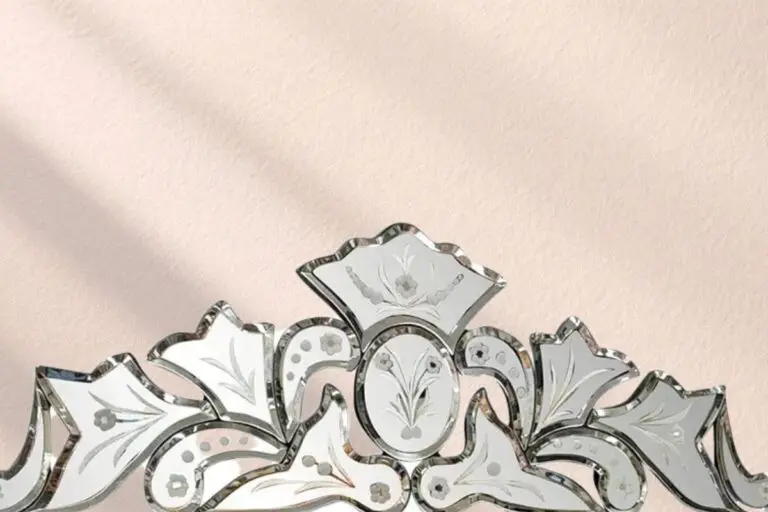 rnate Venetian etched glass mirror crest detail against warm plaster wall — vintage home interior mirror for old houses