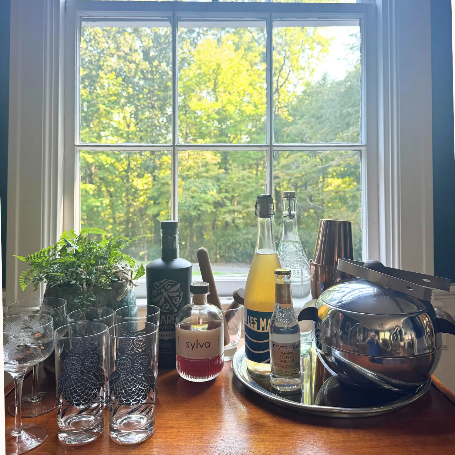 Vintage chrome penguin ice bucket, tray and tongs on a bar cart in a 1924 old house