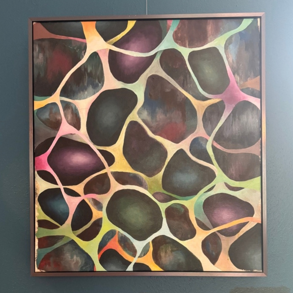 Colorful abstract acrylic painting by Sydney Rubin hanging from a picture rail on a blue dining room wall